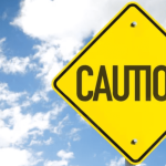 Caution Sign against blue sky